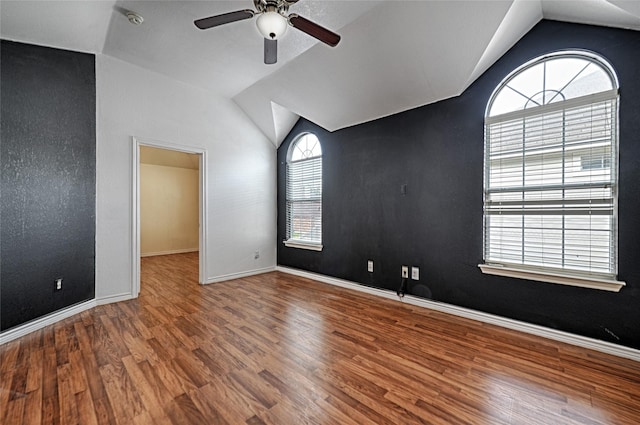 spare room featuring hardwood / wood-style flooring, ceiling fan, and lofted ceiling