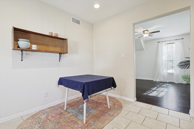 interior space with light tile patterned floors and ceiling fan