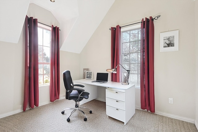 office featuring light colored carpet, a wealth of natural light, and vaulted ceiling