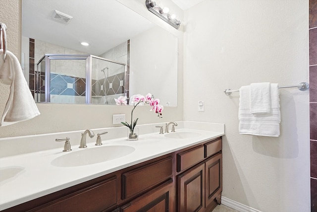 bathroom featuring vanity and an enclosed shower