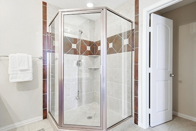 bathroom with tile patterned flooring and a shower with door