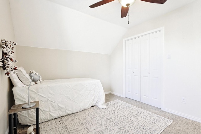 carpeted bedroom featuring ceiling fan, lofted ceiling, and a closet