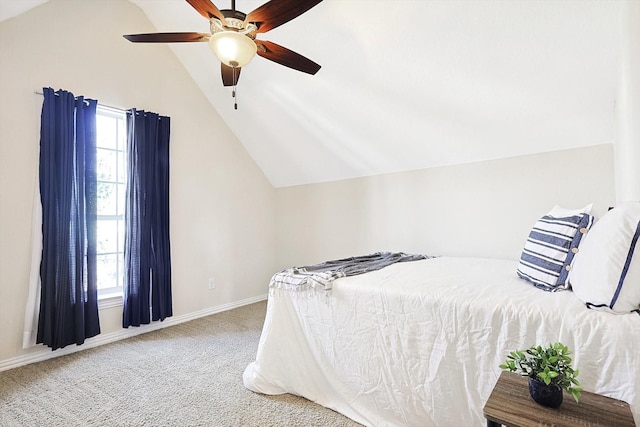 carpeted bedroom featuring ceiling fan, multiple windows, and vaulted ceiling