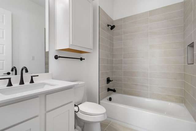 full bathroom with tile patterned flooring, toilet, vanity, and tiled shower / bath