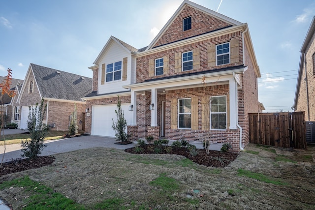 view of front of house featuring a garage, a front yard, and a porch