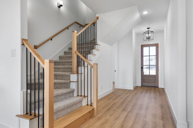 foyer featuring light wood-type flooring and an inviting chandelier