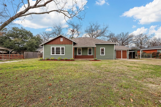 rear view of house featuring a yard