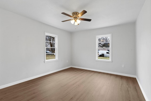 unfurnished room with wood-type flooring, plenty of natural light, and ceiling fan