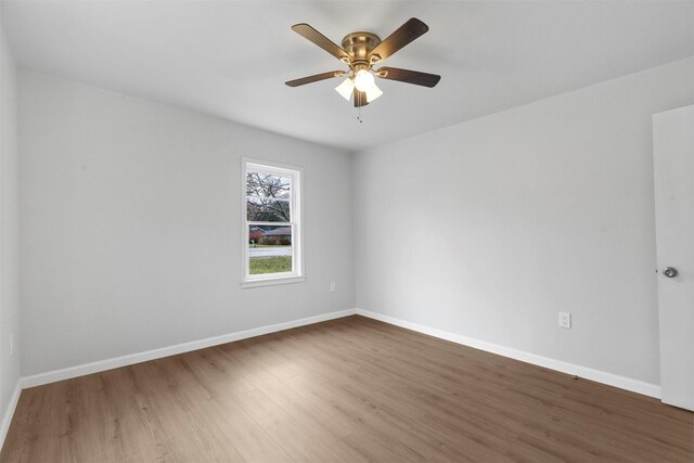 unfurnished room featuring ceiling fan and dark hardwood / wood-style flooring