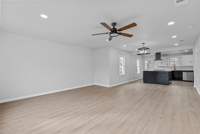 unfurnished living room with light hardwood / wood-style flooring and ceiling fan