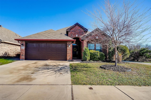 view of front of house featuring a garage and a front lawn