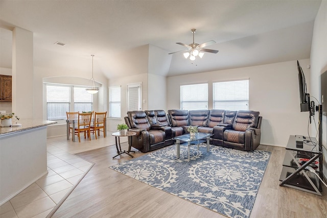 living room featuring light hardwood / wood-style floors, plenty of natural light, ceiling fan, and lofted ceiling