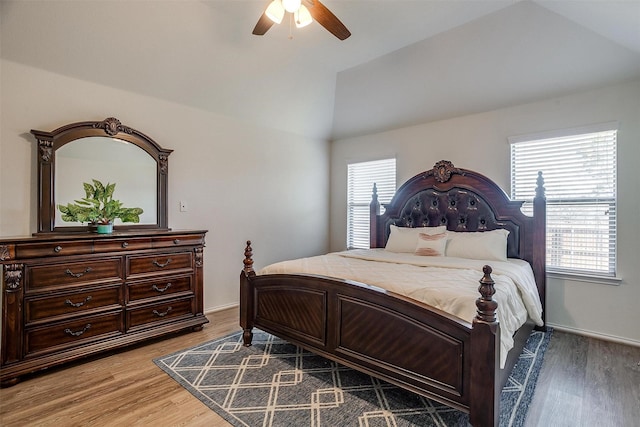 bedroom featuring ceiling fan, wood-type flooring, and lofted ceiling