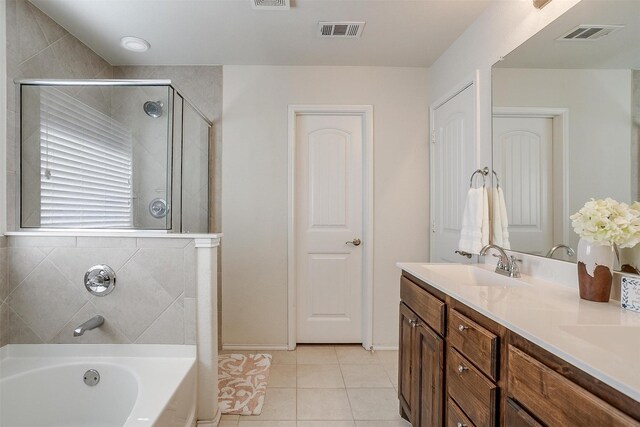 bathroom with tile patterned flooring, vanity, and independent shower and bath