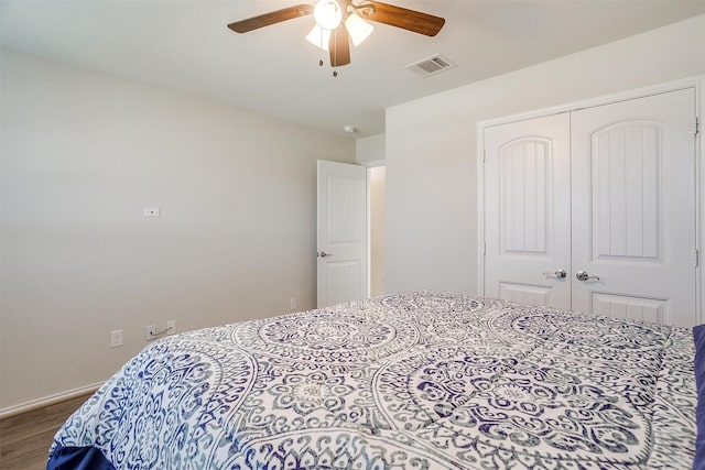 bedroom with hardwood / wood-style floors, a closet, and ceiling fan