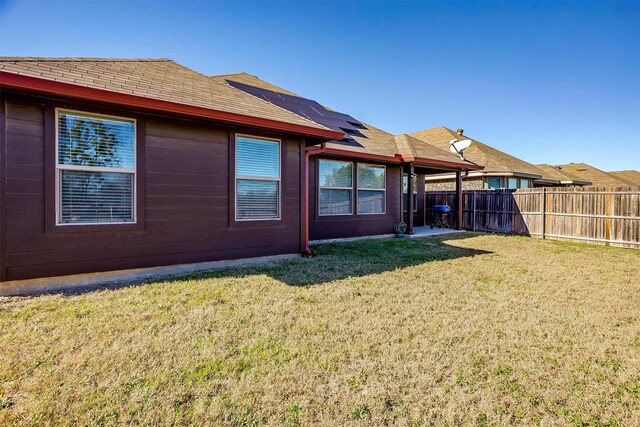 rear view of property featuring a yard