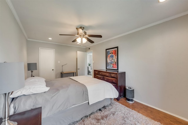 bedroom featuring crown molding, ceiling fan, and hardwood / wood-style floors