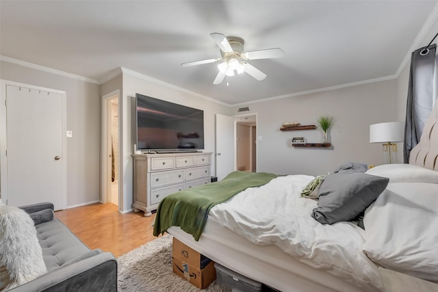 bedroom with crown molding, ceiling fan, and light hardwood / wood-style floors