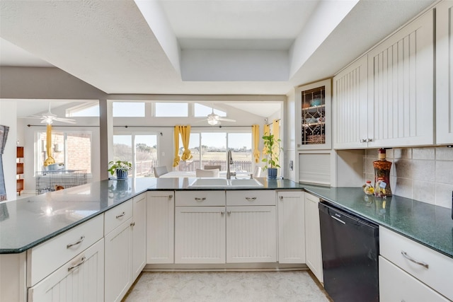 kitchen featuring dishwasher, sink, white cabinets, backsplash, and kitchen peninsula