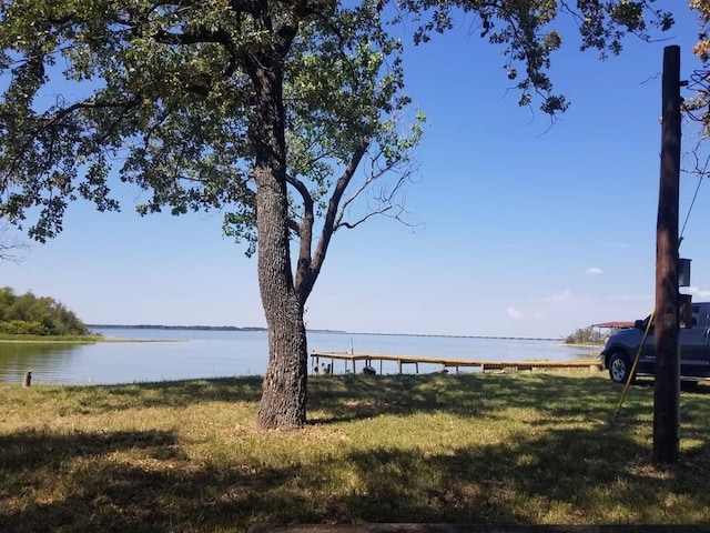 exterior space with a water view and a yard