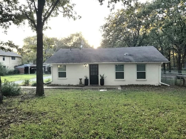 rear view of property featuring a yard