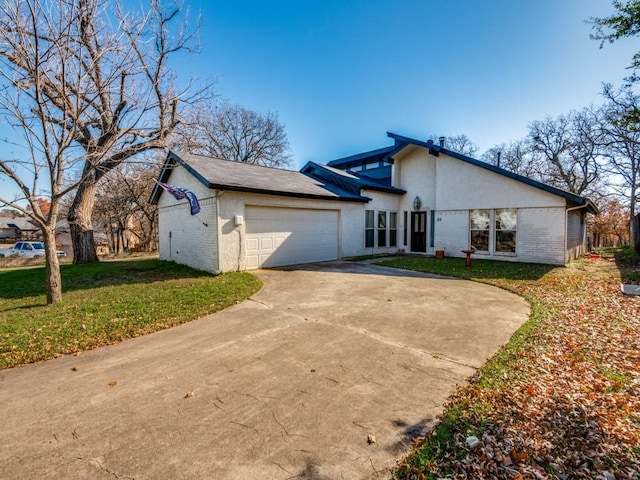 view of front of property with a garage and a front yard