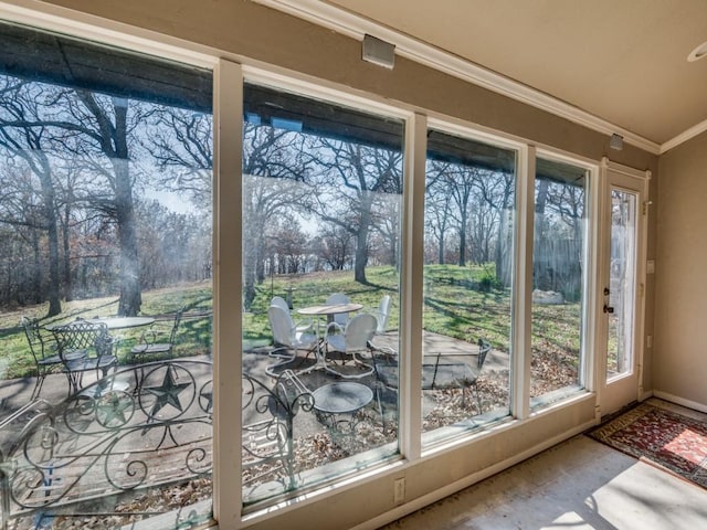 doorway to outside with ornamental molding