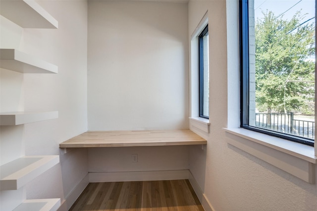 interior space with hardwood / wood-style floors and built in desk