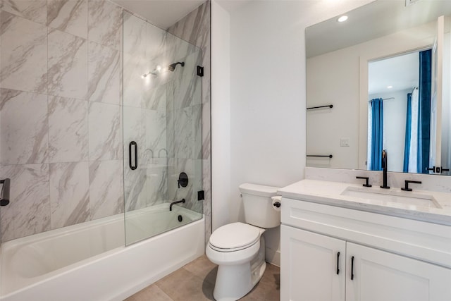 full bathroom with combined bath / shower with glass door, tile patterned floors, vanity, and toilet