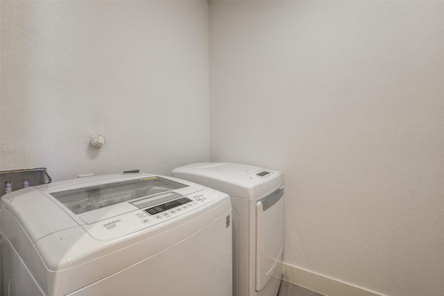 clothes washing area with separate washer and dryer