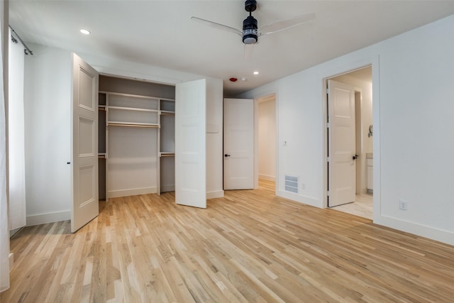 unfurnished bedroom featuring connected bathroom, ceiling fan, a closet, and light wood-type flooring