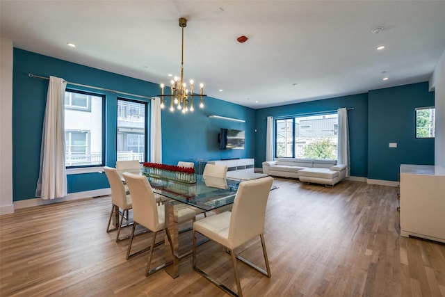 dining area featuring a chandelier and light hardwood / wood-style floors