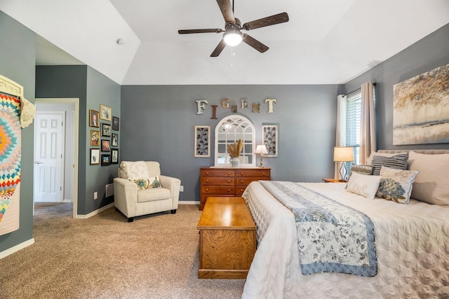 carpeted bedroom featuring ceiling fan and a raised ceiling