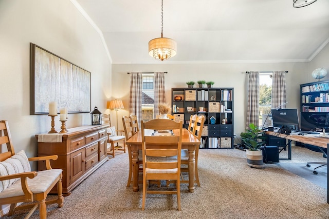 carpeted dining area featuring crown molding and lofted ceiling