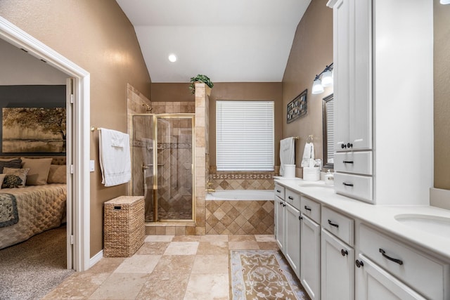 bathroom featuring plus walk in shower, vanity, and vaulted ceiling