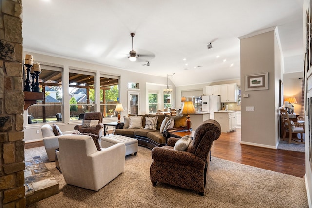 living room featuring ceiling fan, wood-type flooring, crown molding, and vaulted ceiling