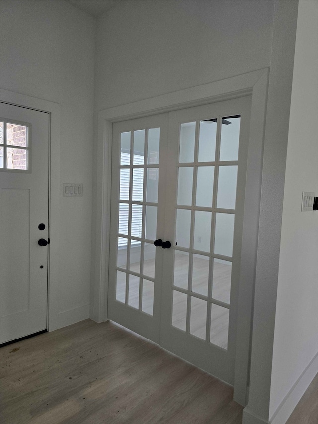 entryway featuring french doors and light wood-type flooring