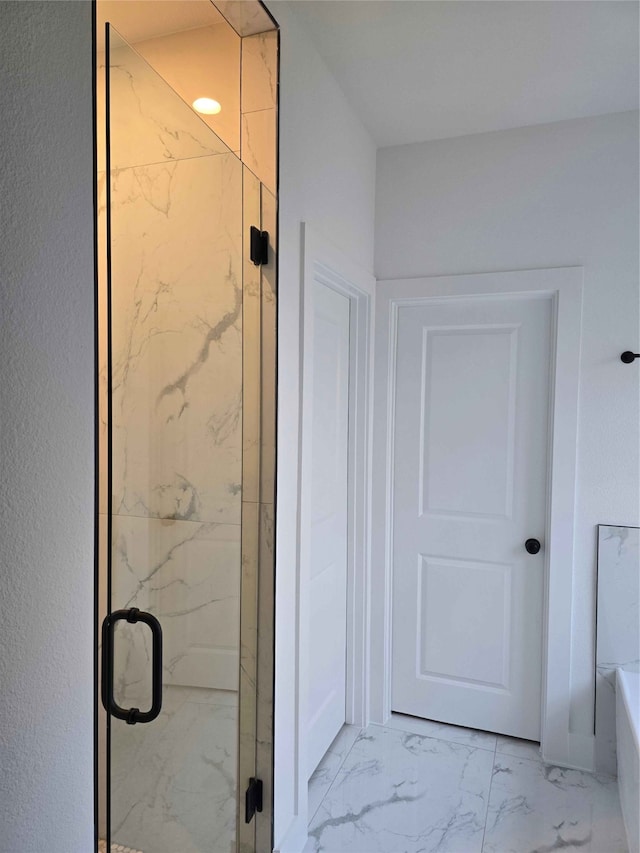 bathroom with a shower with shower door