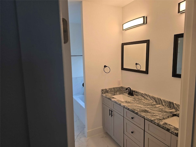 bathroom featuring vanity and a relaxing tiled tub