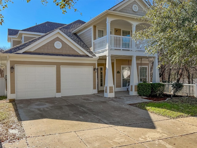 view of front of property featuring a garage and a balcony