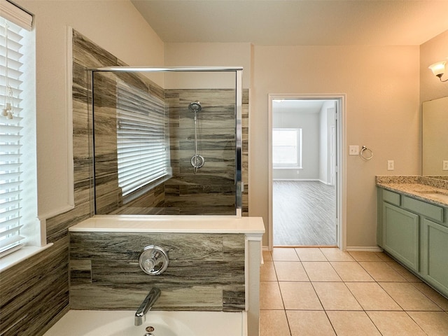 bathroom with tile patterned floors, vanity, and a tile shower