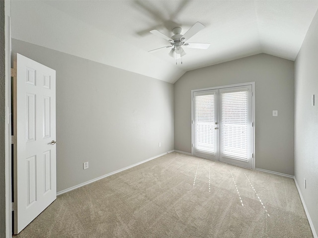 carpeted spare room with lofted ceiling and ceiling fan