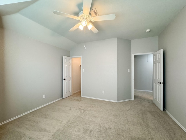 unfurnished bedroom with ceiling fan, light colored carpet, and lofted ceiling