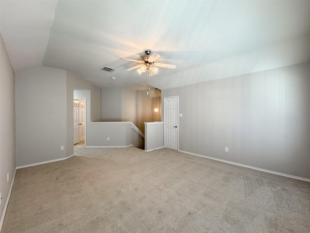 interior space with lofted ceiling, light colored carpet, and ceiling fan