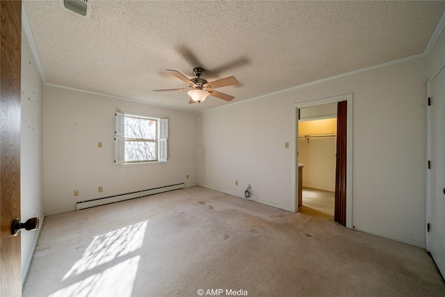 unfurnished bedroom with a closet, light colored carpet, baseboard heating, ornamental molding, and a textured ceiling