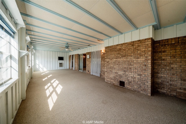 206 Spoon Dr, Stamford, TX 79553 - interior space with carpet floors, a ceiling fan, and brick wall