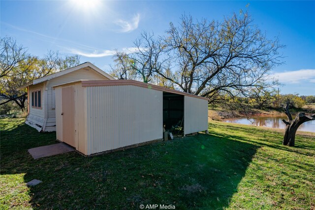 206 Spoon Dr, Stamford, TX 79553 - view of outbuilding featuring a water view and an outdoor structure
