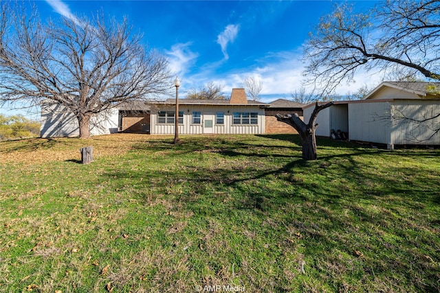 back of house with a yard