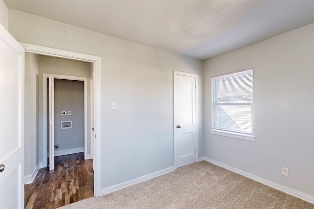 unfurnished bedroom with dark carpet