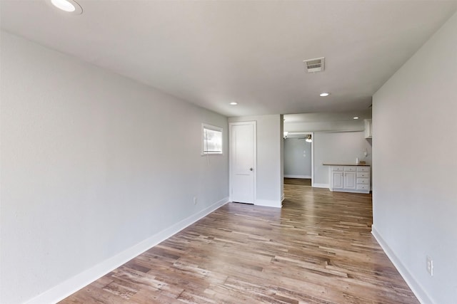 empty room with ceiling fan and wood-type flooring